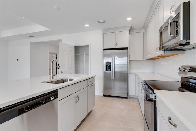 10008 Last Light Gln, Parrish, FL 34219 - kitchen with appliances with stainless steel finishes, a sink, light countertops, decorative backsplash, and visible vents