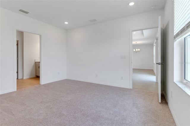 10008 Last Light Gln, Parrish, FL 34219 - spare room with light carpet, a notable chandelier, recessed lighting, and visible vents