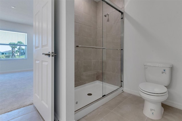 10008 Last Light Gln, Parrish, FL 34219 - full bathroom with toilet, baseboards, a shower stall, and tile patterned flooring