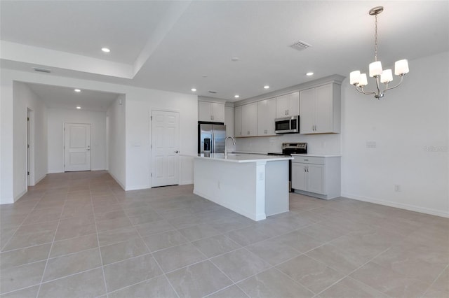 10008 Last Light Gln, Parrish, FL 34219 - kitchen featuring an inviting chandelier, visible vents, light countertops, a sink, and stainless steel appliances