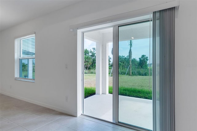 10008 Last Light Gln, Parrish, FL 34219 - doorway to outside featuring baseboards and light tile patterned floors