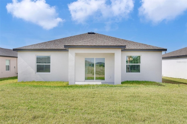 10008 Last Light Gln, Parrish, FL 34219 - rear view of property featuring a yard, a shingled roof, and stucco siding