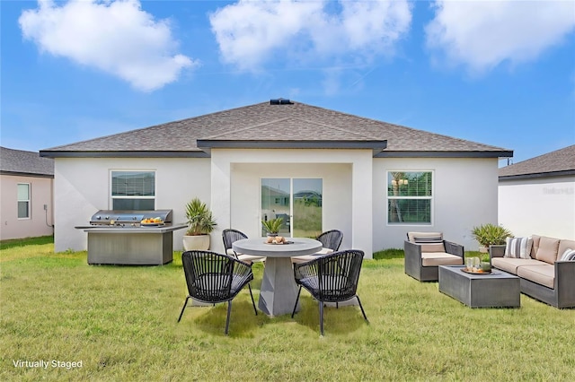 10008 Last Light Gln, Parrish, FL 34219 - back of property with an outdoor living space with a fire pit, roof with shingles, and a lawn