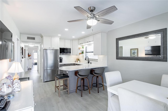 865 Ladyfish Ave Unit C104, New Smyrna Beach, FL 32169 - kitchen with plenty of natural light, a sink, light wood-style floors, and appliances with stainless steel finishes