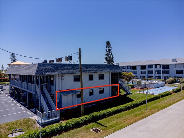 865 Ladyfish Ave Unit C104, New Smyrna Beach, FL 32169 - view of property with uncovered parking and stairway