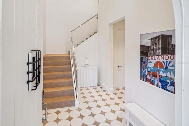 stairway with tile patterned floors