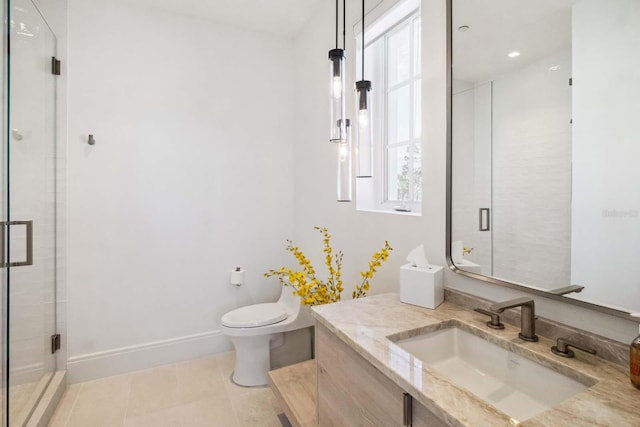 bathroom featuring a shower stall, tile patterned floors, vanity, baseboards, and toilet