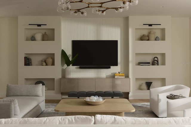 living area with wood finished floors, built in features, and an inviting chandelier