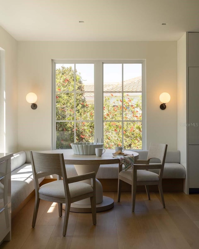 dining area featuring breakfast area and light wood finished floors