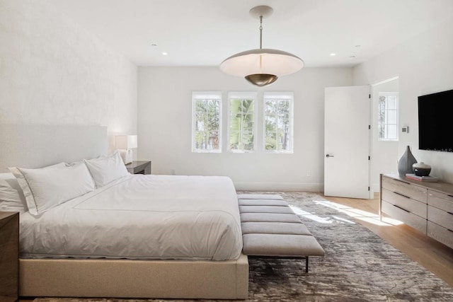 bedroom featuring multiple windows and recessed lighting
