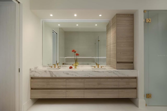 bathroom with a sink, double vanity, and recessed lighting