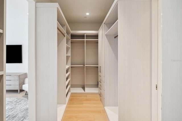 walk in closet featuring wood finished floors