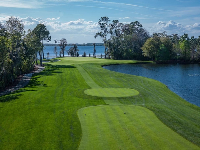 view of property's community with view of golf course and a water view