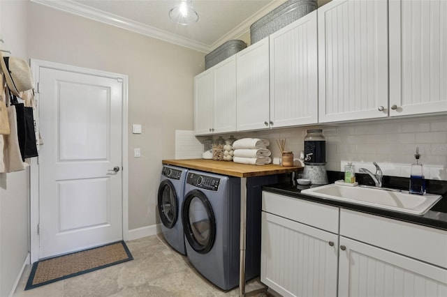 11725 Verrazano Dr, Orlando, FL 32836 - laundry area featuring washing machine and dryer, ornamental molding, cabinet space, and baseboards