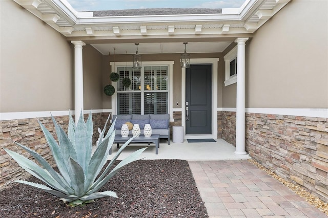 11725 Verrazano Dr, Orlando, FL 32836 - view of exterior entry featuring stucco siding, stone siding, and a porch