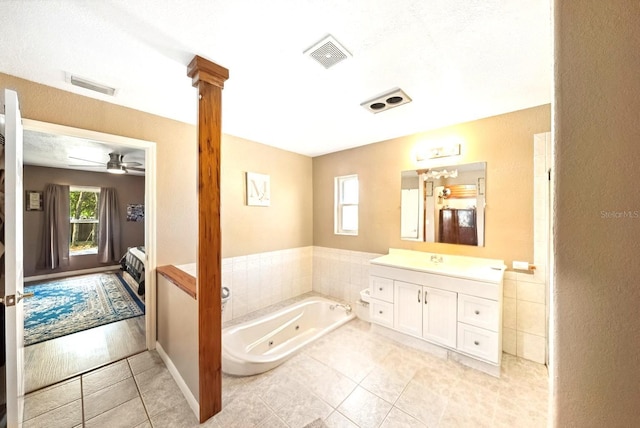 3512 W Whippoorwill St, Lecanto, FL 34461 - ensuite bathroom featuring vanity, a tub with jets, tile patterned flooring, and a ceiling fan