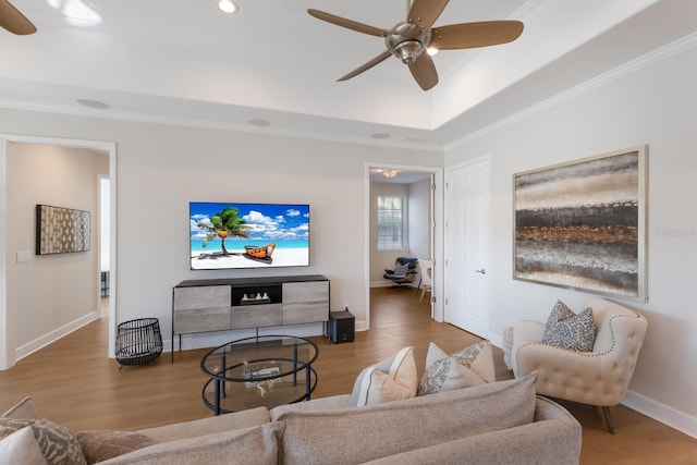8035 St Simons St Unit 8035, University Park, FL 34201 - living area featuring baseboards, crown molding, ceiling fan, a raised ceiling, and wood finished floors
