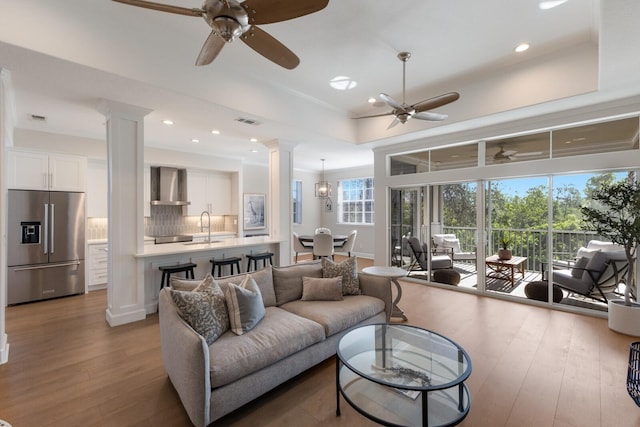 8035 St Simons St Unit 8035, University Park, FL 34201 - living room featuring wood-type flooring, ceiling fan, decorative columns, and visible vents