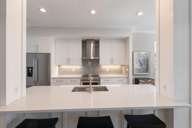 8035 St Simons St Unit 8035, University Park, FL 34201 - kitchen featuring wall chimney exhaust hood, stainless steel appliances, white cabinets, tasteful backsplash, and ornamental molding