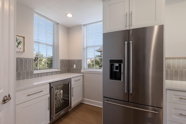 8035 St Simons St Unit 8035, University Park, FL 34201 - kitchen with wine cooler, high end refrigerator, light countertops, and decorative backsplash