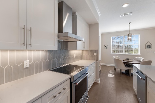 8035 St Simons St Unit 8035, University Park, FL 34201 - kitchen with white cabinets, wall chimney exhaust hood, appliances with stainless steel finishes, and visible vents