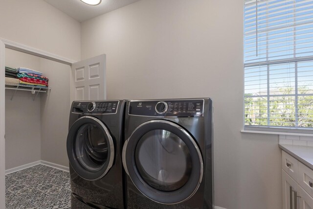 8035 St Simons St Unit 8035, University Park, FL 34201 - clothes washing area with baseboards, cabinet space, and independent washer and dryer