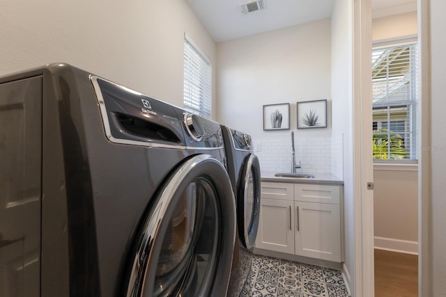 8035 St Simons St Unit 8035, University Park, FL 34201 - laundry area featuring a sink, washer and dryer, cabinet space, baseboards, and visible vents