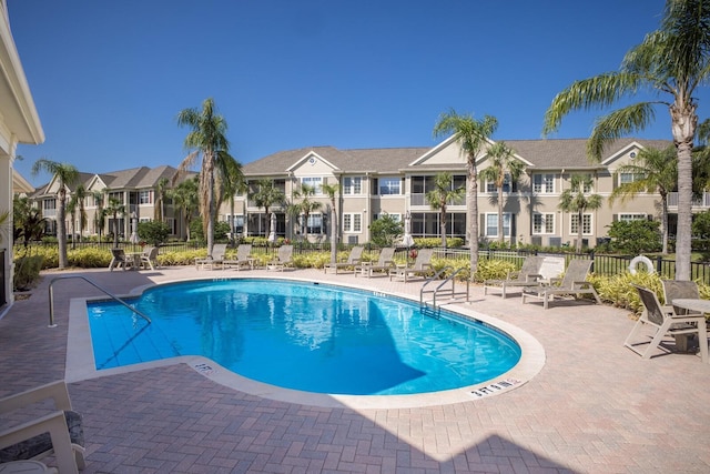 8035 St Simons St Unit 8035, University Park, FL 34201 - community pool featuring a patio, a residential view, and fence