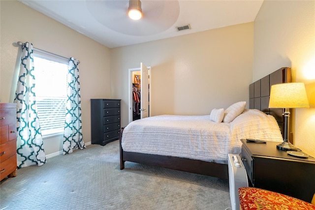 3509 Battersea Ct, Belle Isle, FL 32812 - bedroom with visible vents, light carpet, a walk in closet, baseboards, and ceiling fan