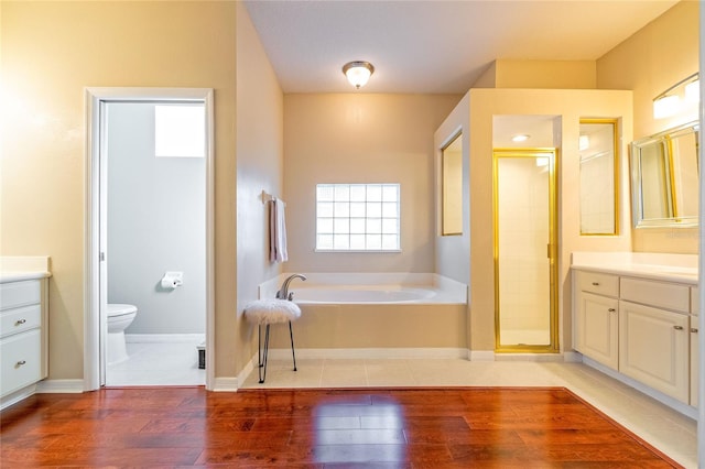 3509 Battersea Ct, Belle Isle, FL 32812 - full bathroom with a bath, wood finished floors, toilet, and vanity