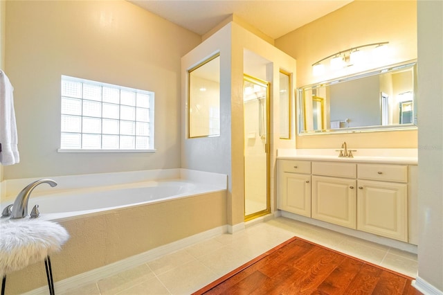 3509 Battersea Ct, Belle Isle, FL 32812 - bathroom with a garden tub, tile patterned flooring, a stall shower, and vanity