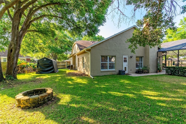 3509 Battersea Ct, Belle Isle, FL 32812 - rear view of house featuring central AC unit, a patio area, an outdoor fire pit, a fenced backyard, and stucco siding