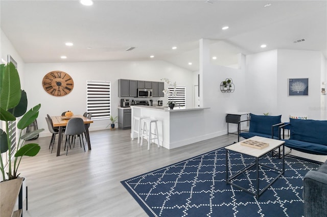 7803 Laurel Oak Ln, Kissimmee, FL 34747 - living room with recessed lighting, visible vents, light wood-style flooring, and lofted ceiling