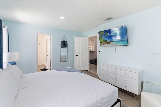 7803 Laurel Oak Ln, Kissimmee, FL 34747 - bedroom featuring recessed lighting, a textured ceiling, visible vents, and wood finished floors