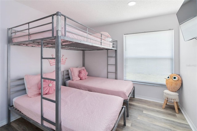 7803 Laurel Oak Ln, Kissimmee, FL 34747 - bedroom with baseboards, a textured ceiling, recessed lighting, and wood finished floors