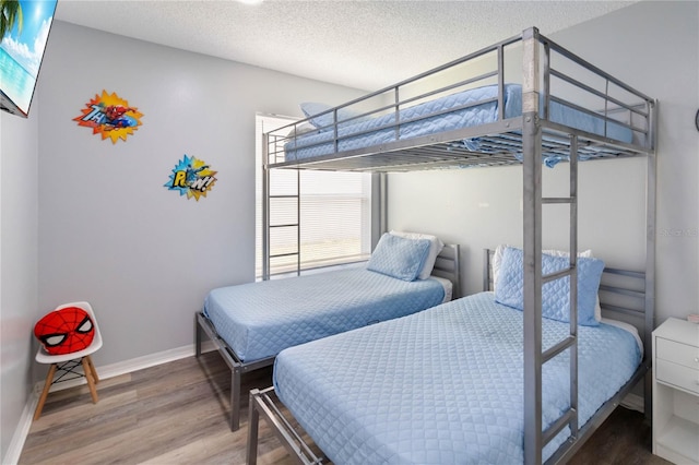 7803 Laurel Oak Ln, Kissimmee, FL 34747 - bedroom featuring a textured ceiling, baseboards, and wood finished floors