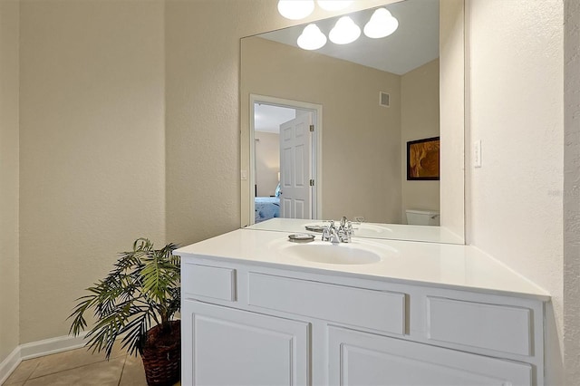 bathroom with tile patterned floors, toilet, visible vents, baseboards, and vanity