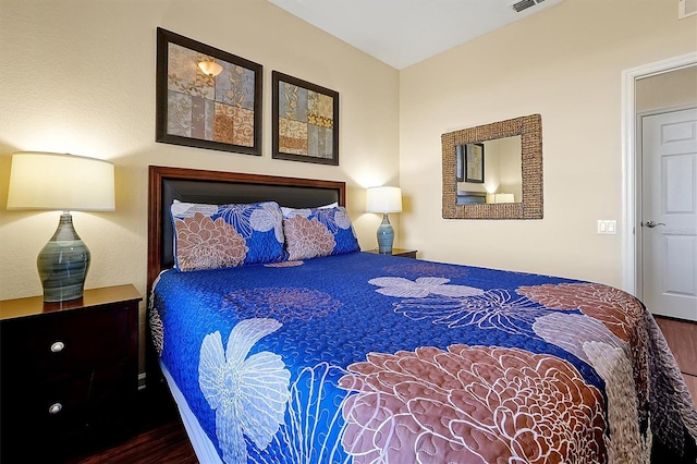 bedroom featuring wood finished floors and visible vents