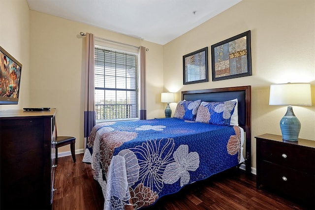 bedroom featuring baseboards and wood finished floors