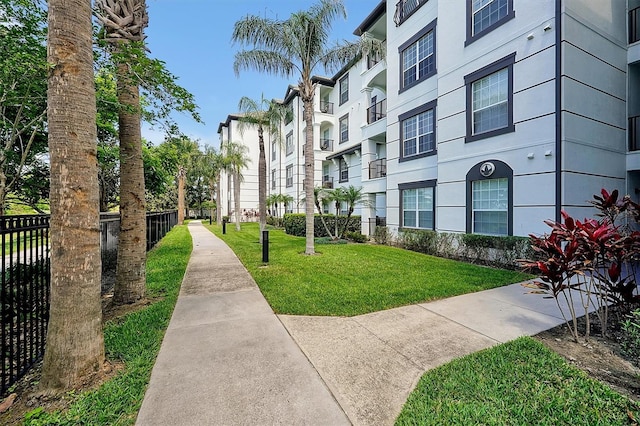 surrounding community featuring fence and a yard