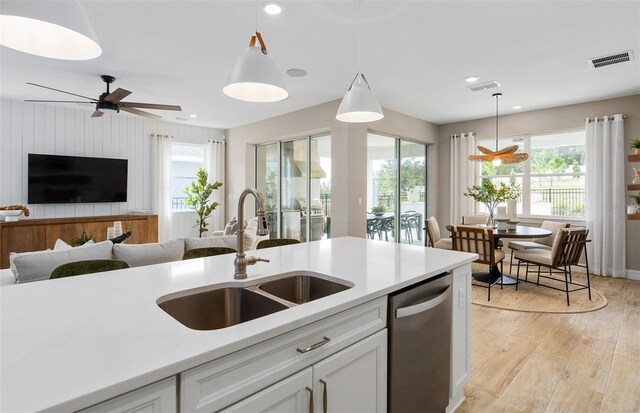 2717 Serenity Meadow Dr, Kissimmee, FL 34744 - kitchen featuring plenty of natural light, visible vents, stainless steel dishwasher, and a sink