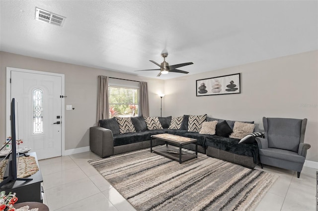 197 Flame Ave, Maitland, FL 32751 - living area with a textured ceiling, light tile patterned floors, ceiling fan, baseboards, and visible vents