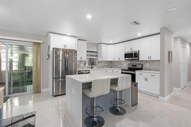 197 Flame Ave, Maitland, FL 32751 - kitchen with stainless steel appliances, light countertops, baseboards, and a sink