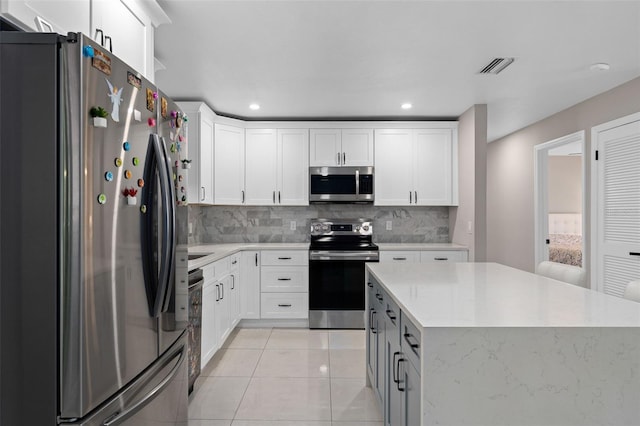 197 Flame Ave, Maitland, FL 32751 - kitchen featuring a kitchen island, tasteful backsplash, visible vents, and stainless steel appliances