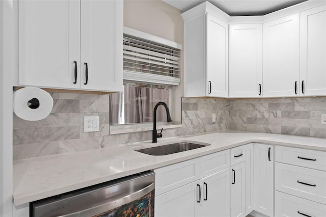 197 Flame Ave, Maitland, FL 32751 - kitchen featuring light stone counters, a sink, dishwasher, white cabinets, and backsplash
