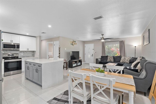 197 Flame Ave, Maitland, FL 32751 - kitchen with stainless steel appliances, light countertops, visible vents, decorative backsplash, and open floor plan