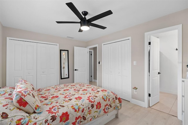 197 Flame Ave, Maitland, FL 32751 - bedroom featuring baseboards, visible vents, light wood-style floors, ceiling fan, and multiple closets