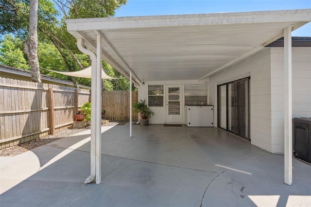 197 Flame Ave, Maitland, FL 32751 - view of patio / terrace with fence and a carport