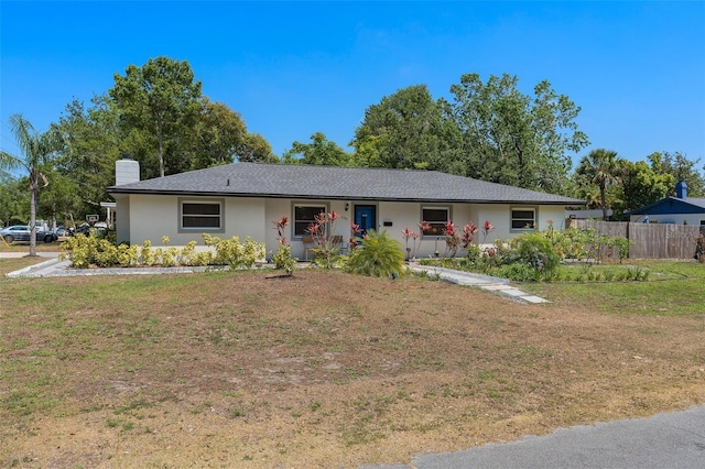 197 Flame Ave, Maitland, FL 32751 - ranch-style home with a chimney, a front lawn, fence, and stucco siding