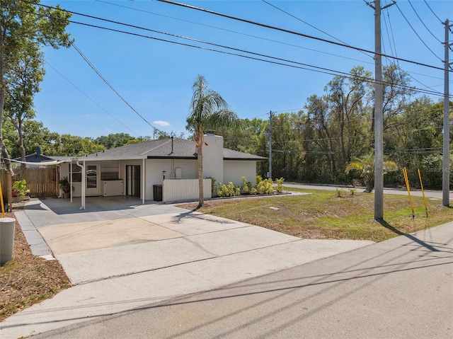 197 Flame Ave, Maitland, FL 32751 - view of front of home featuring driveway, a front yard, fence, and a carport
